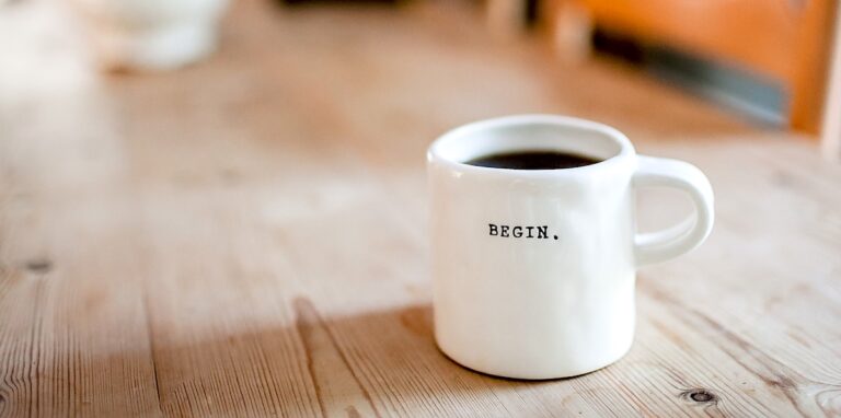 coffee cup that says "begin"
