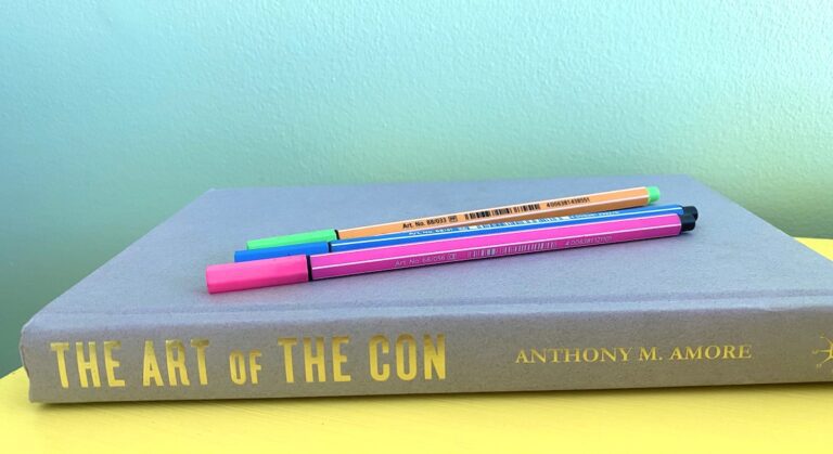 the book 'the art of the con' and pens
