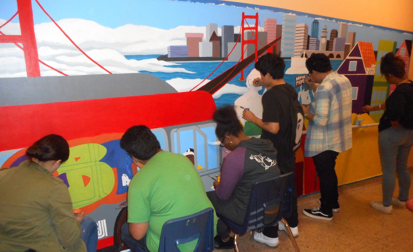 students painting the mural