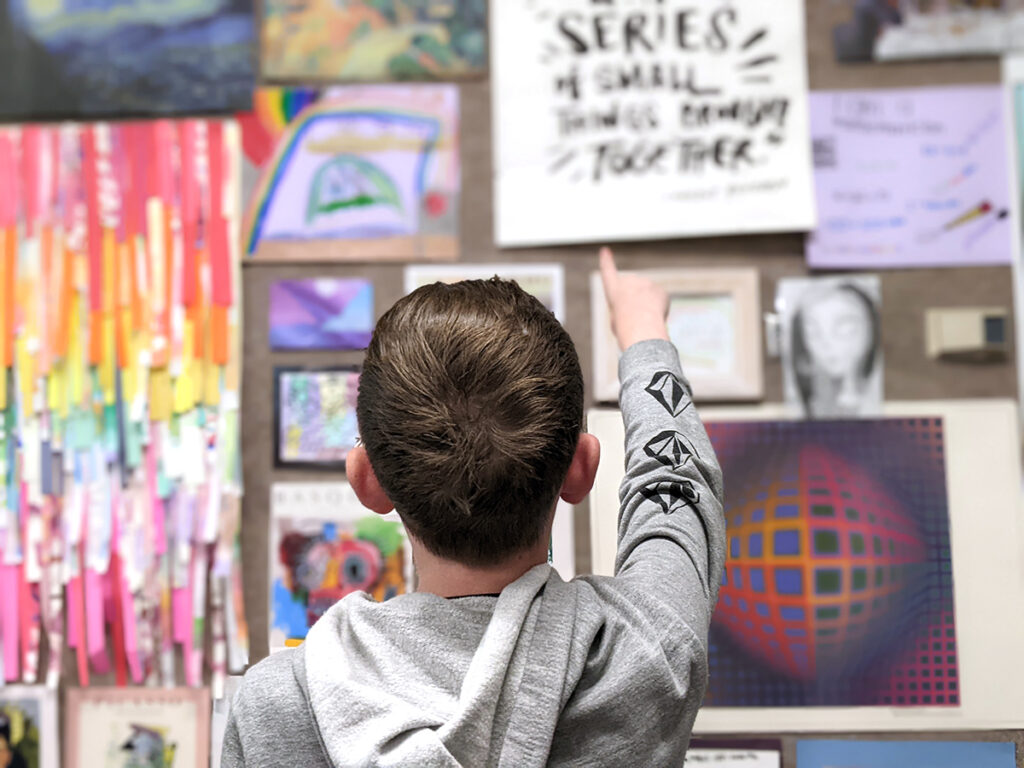 student pointing to artwork