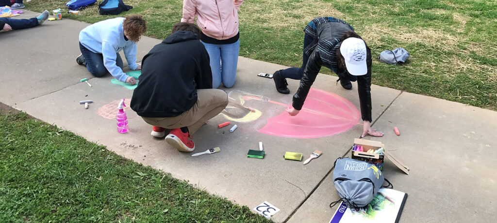 students sidewalk chalk drawing
