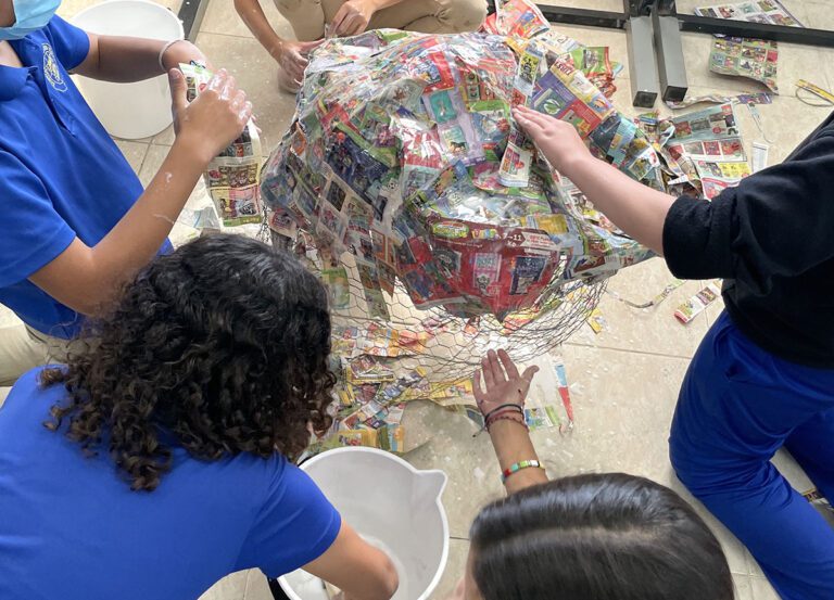 students paper mache together