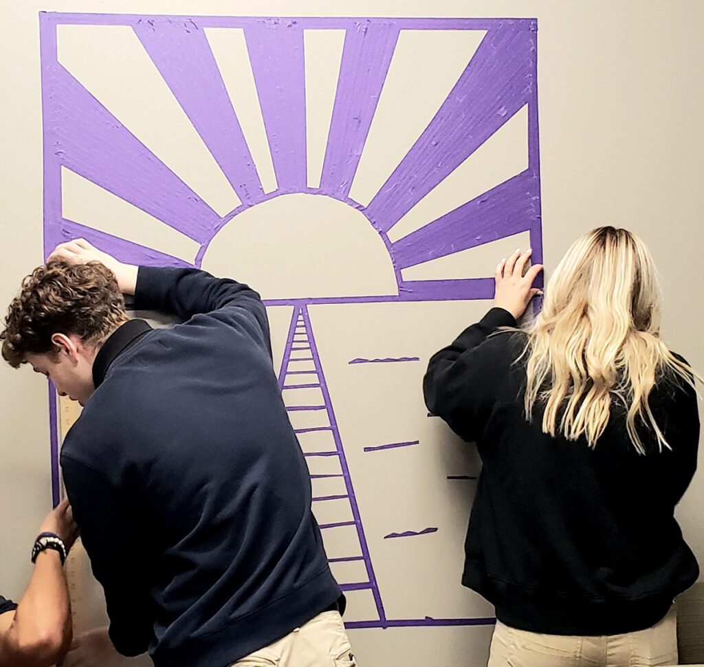 students tape mural