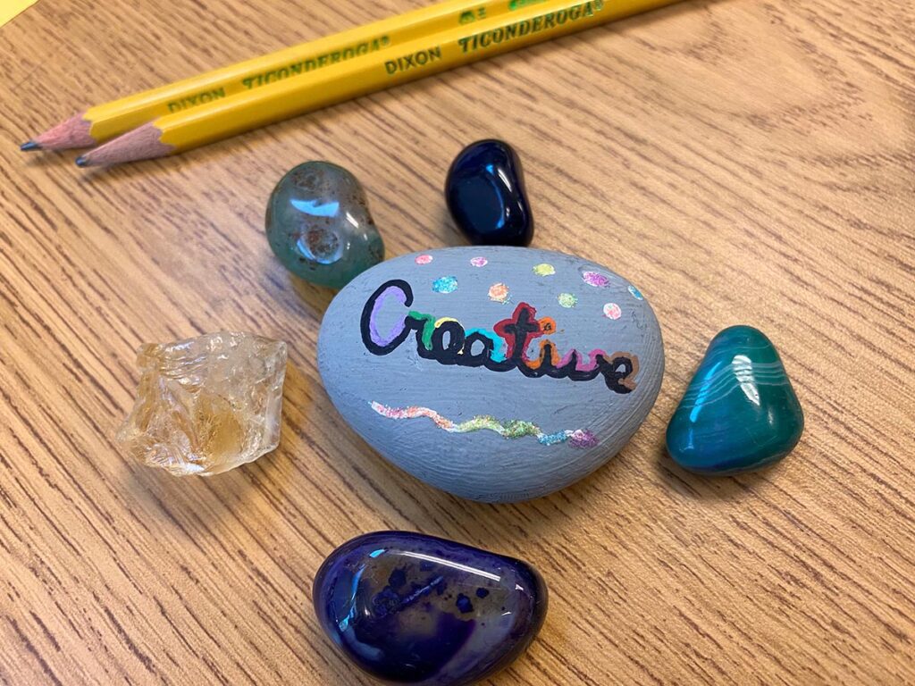 painted rock with word creative