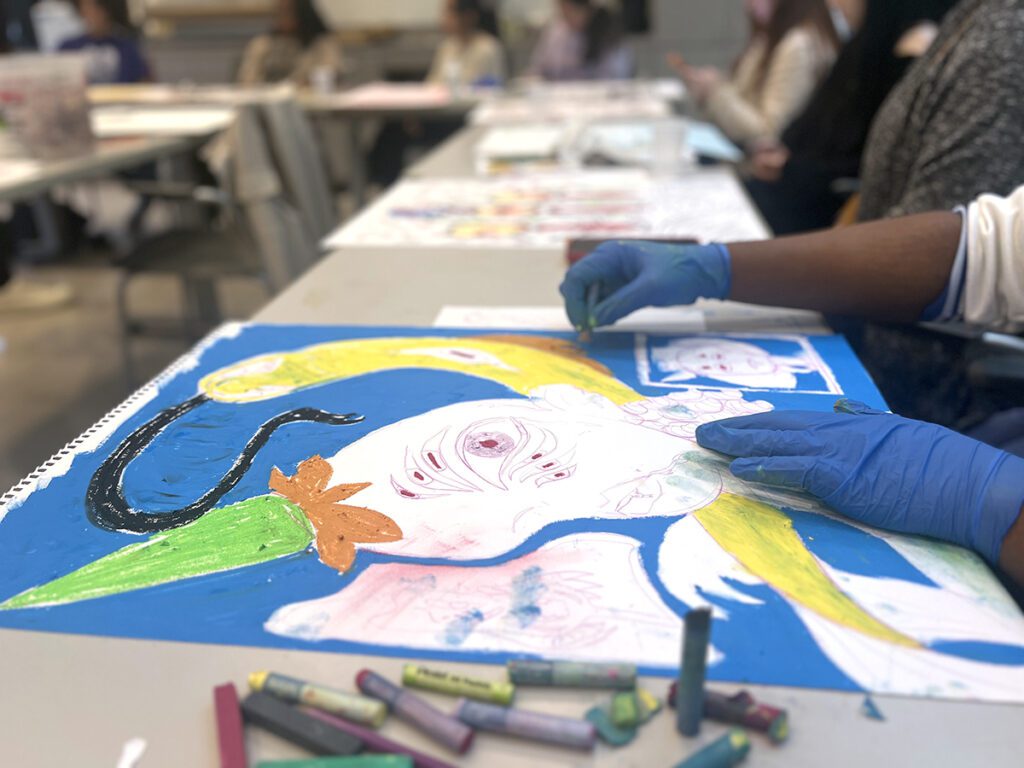 student drawing with pastels