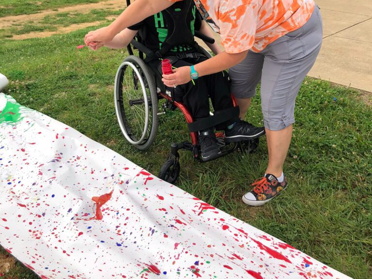 student wheelchair painting