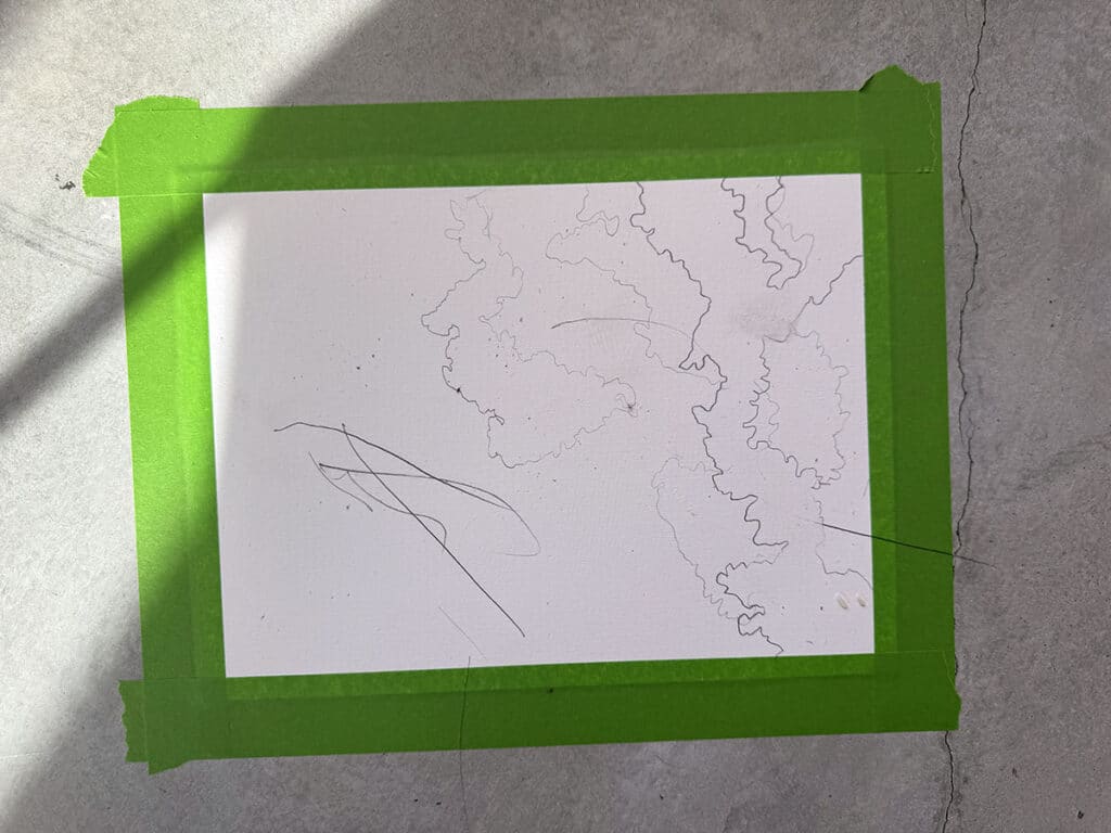 paper with a green tape border and organic pencil marks