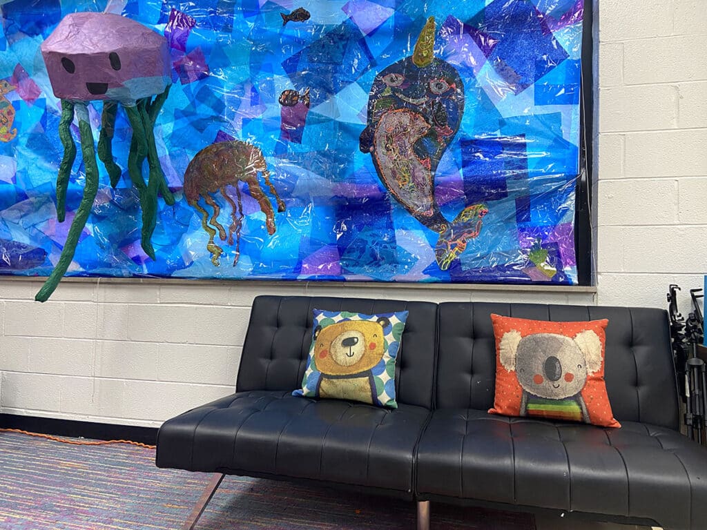 couch with a window mural for an art room calm corner