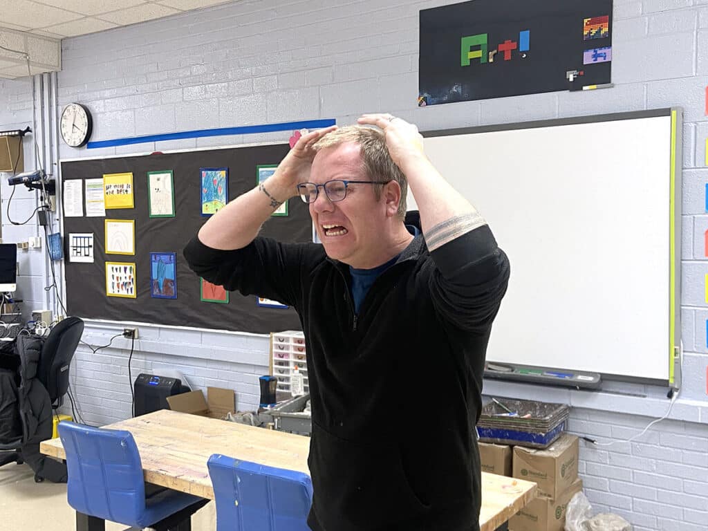 art teacher with hands on head frustrated with classroom management