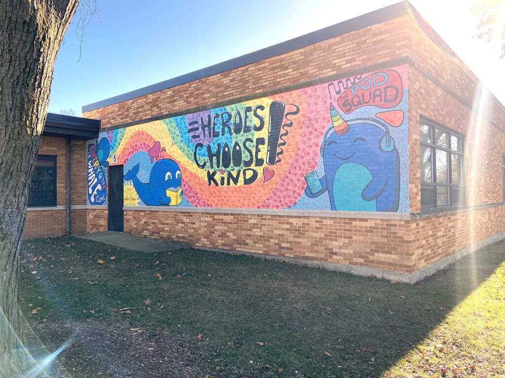 mural on the side of a brick school building
