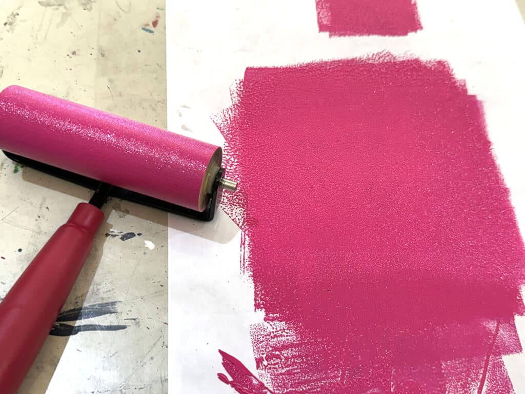 pink ink on paper and brayer