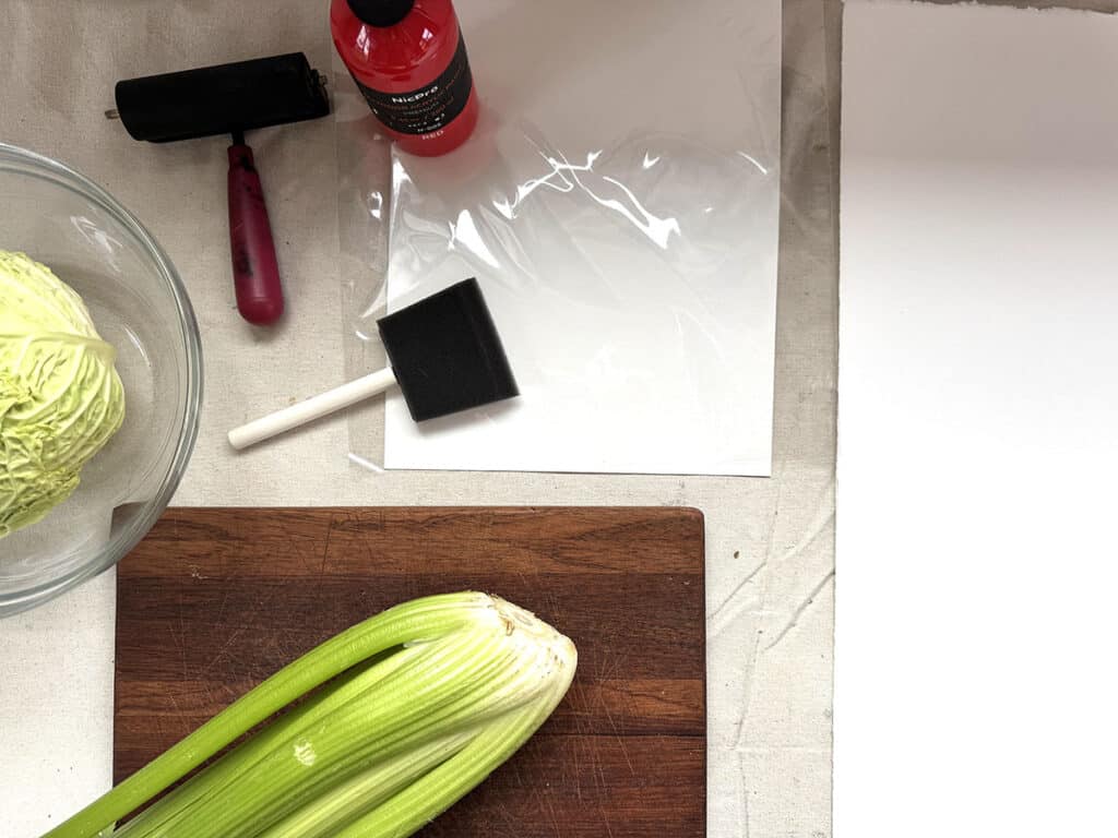 cutting board with celery and printmaking supplies