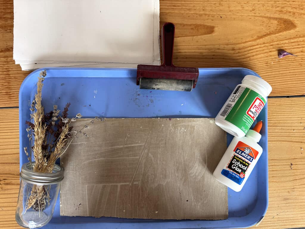tray, cardboard, brayer, glue, dried flowers, paper