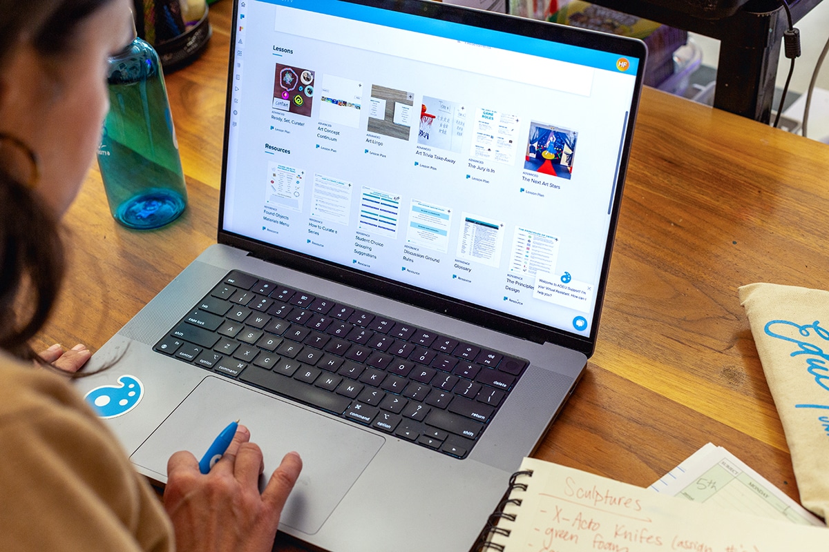 teacher looking at FLEX lessons on a laptop