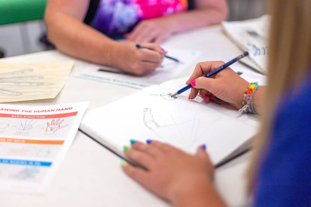 two art teachers drawing together