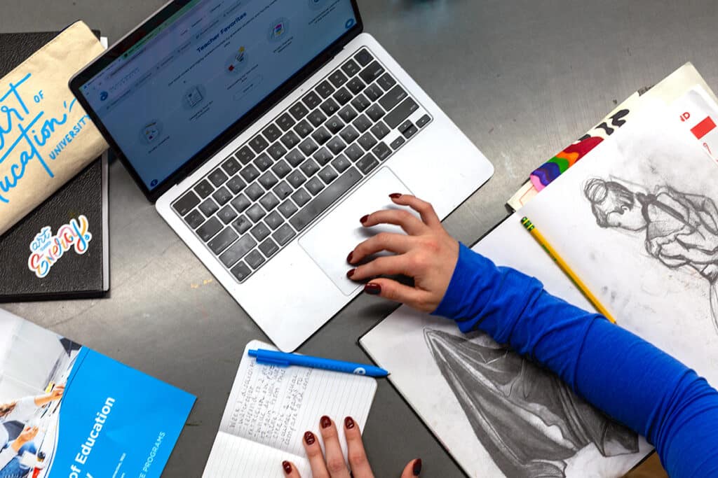 laptop, notebook, and drawings