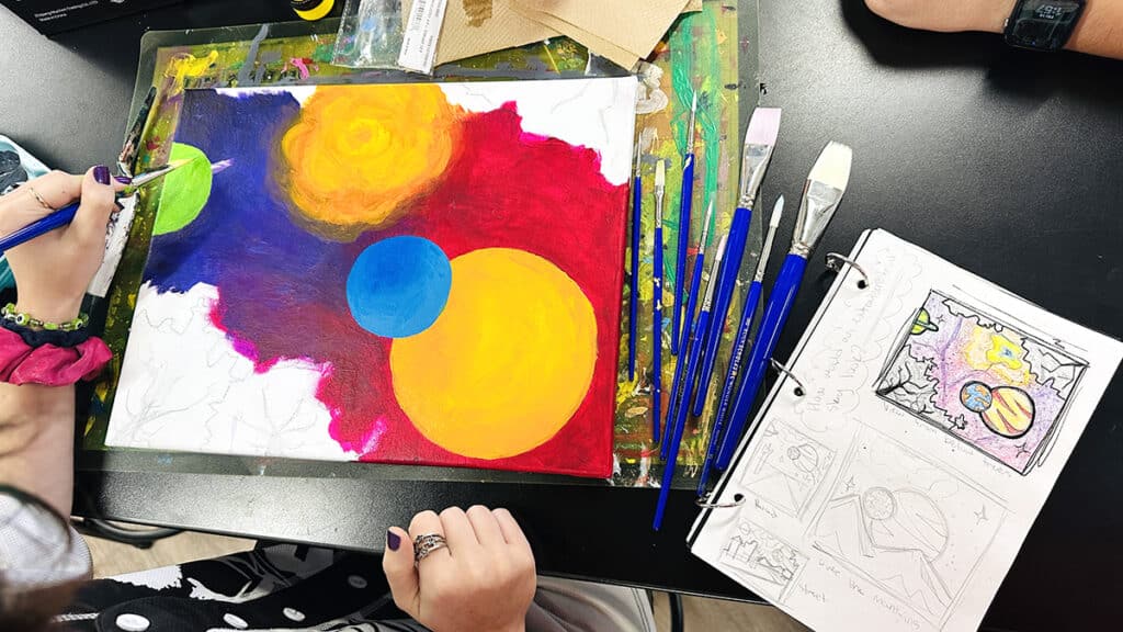 sketchbook with a question and final artwork in progress