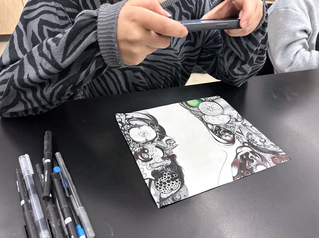 student photographing artwork