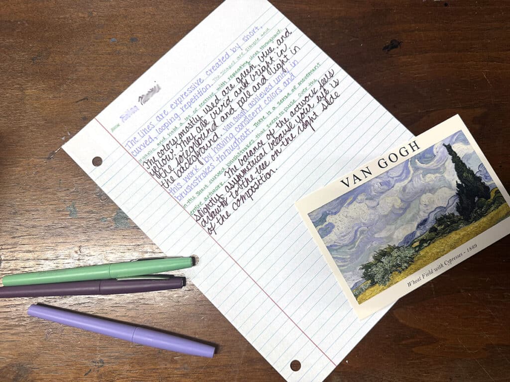 round table activity with paper, artwork, and colored pens