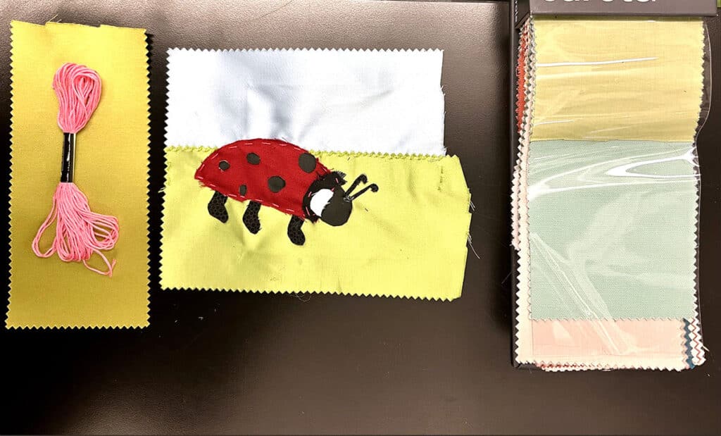 fabric samples, embroidery thread, ladybug artwork