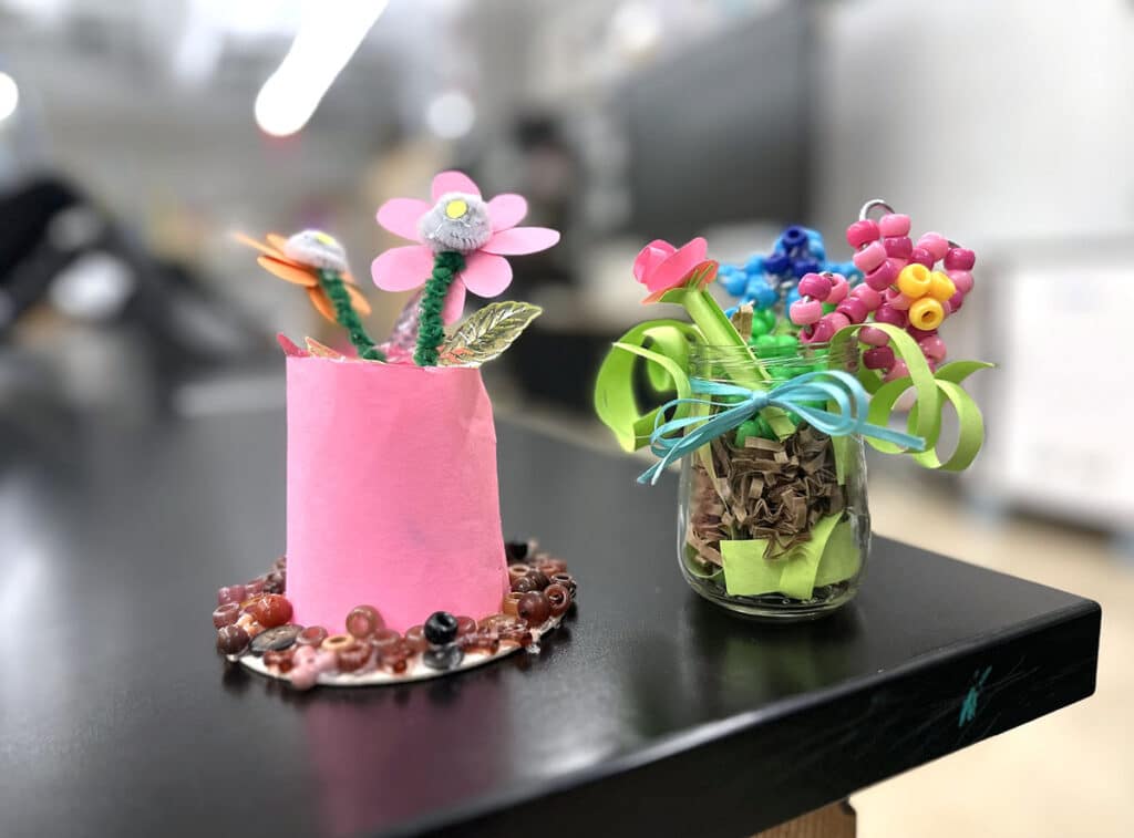 two sculptures made with jars