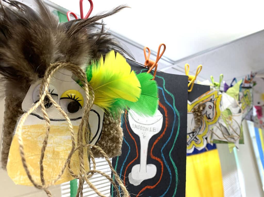 artwork hanging on a line with clips