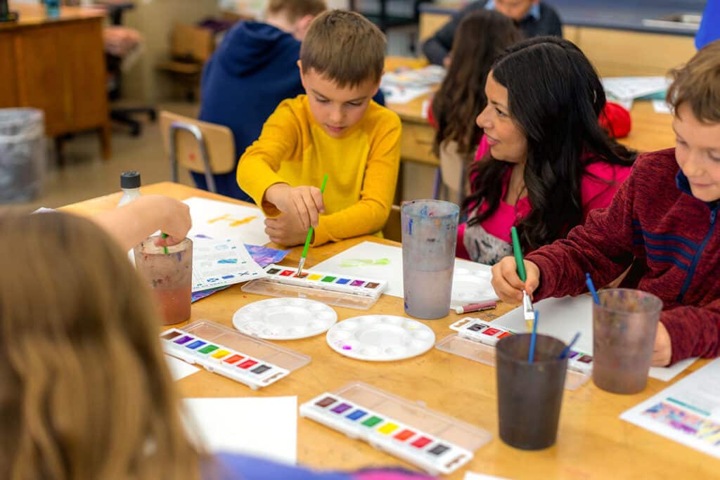 teacher with students painting