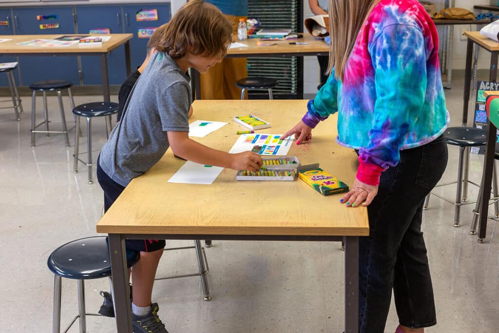 teacher working with a student