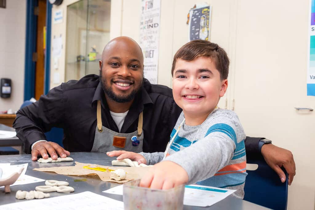 teacher smiling with a student