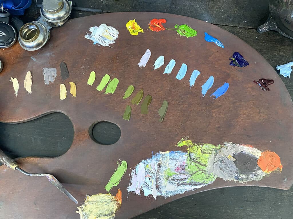 wooden palette, palette knife, and oil paint colors