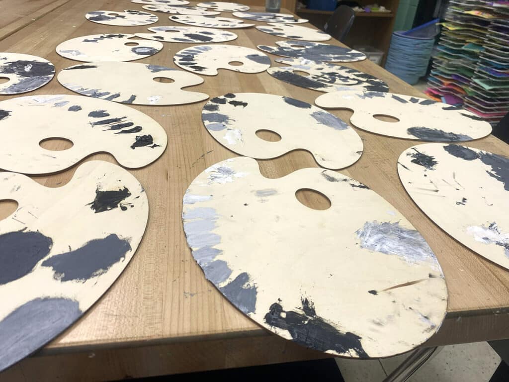 paint palettes with black and white paint on them