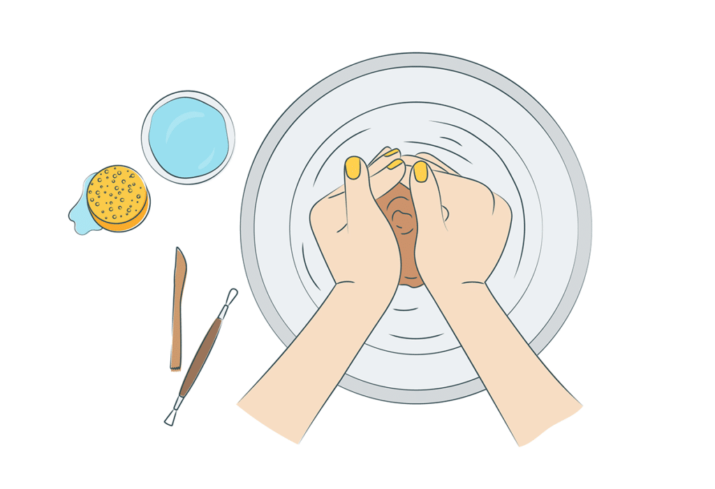 hands molding clay on a pottery wheel