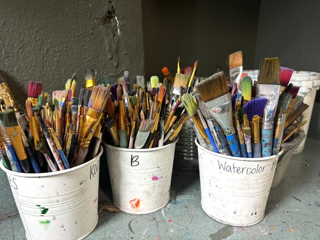 pails of paintbrushes