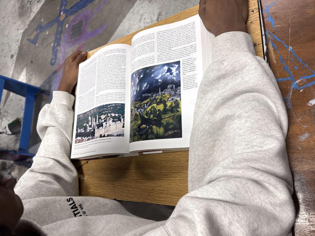 student reading an art textbook