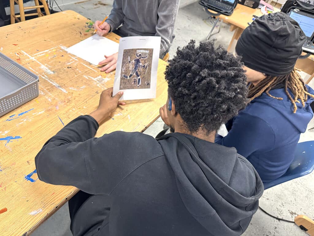 students talking about an artwork together