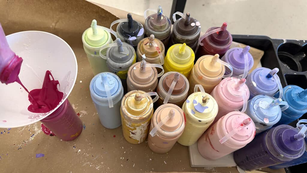 refilling paint bottles with funnel