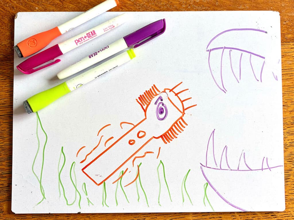 whiteboard with toothbrush flashlight drawing