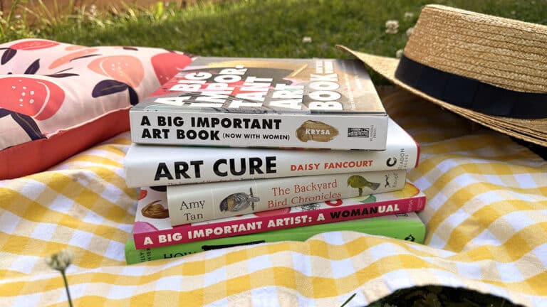 art books on a picnic blanket