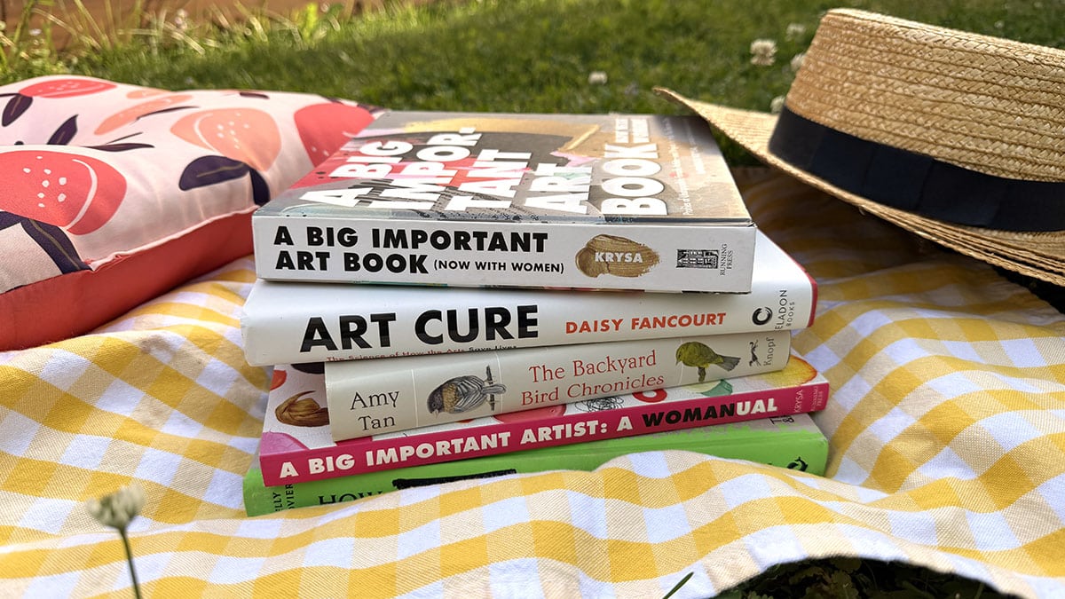 art books on a picnic blanket