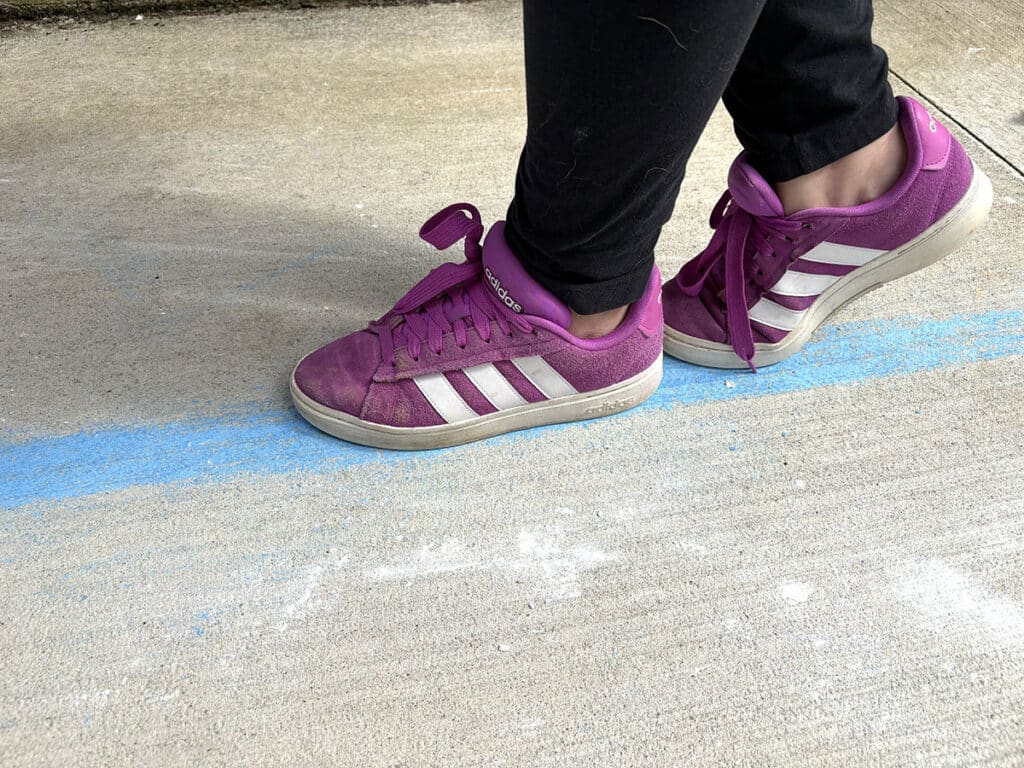 feet walking on a chalk line
