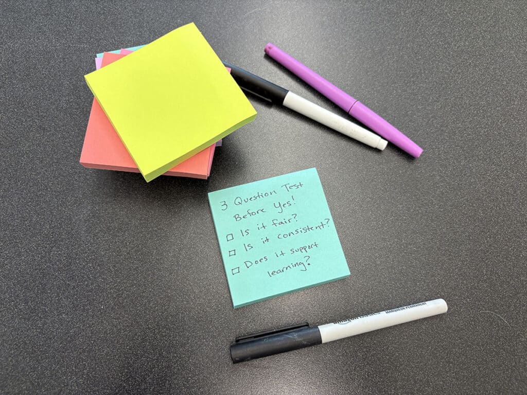 3 question test before yes on sticky note with pens