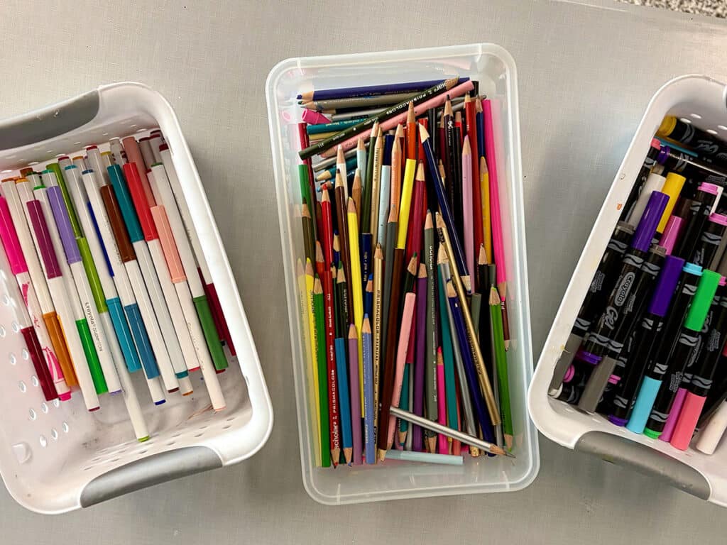 bins of markers and colored pencils