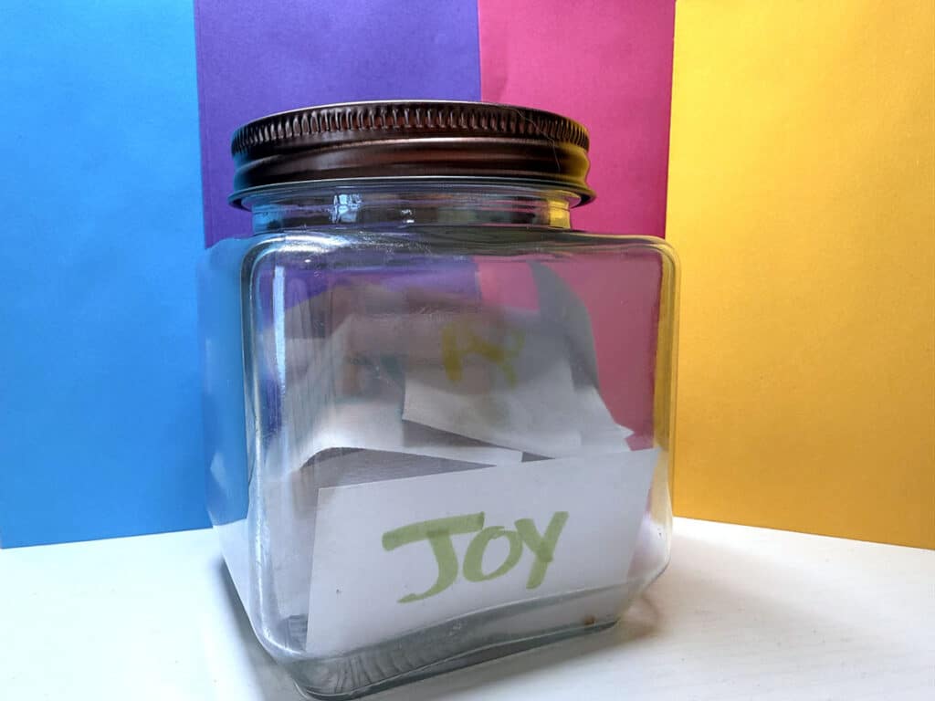 jar with a paper that says joy